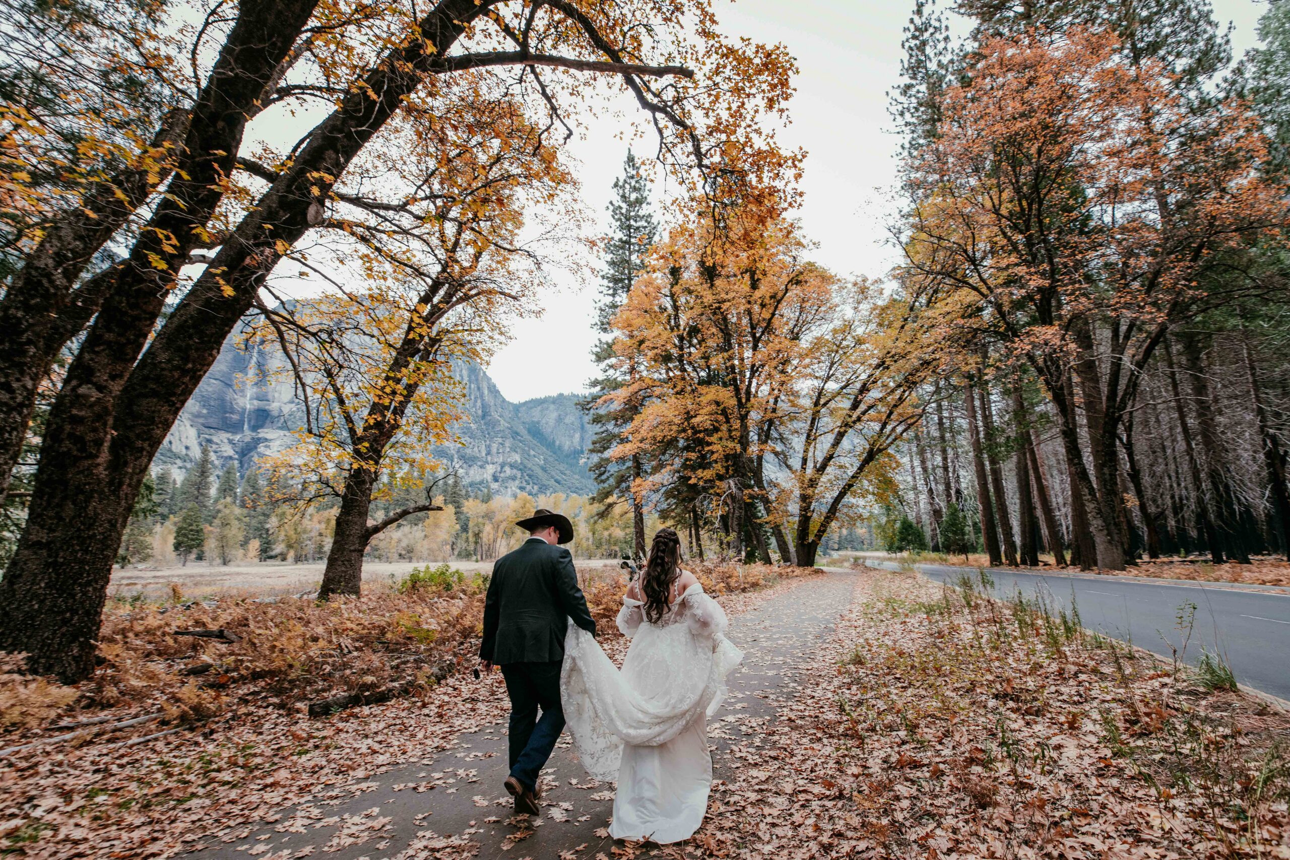 Couple walking through a fall landscape during an intimate elopement, a moment often imagined by couples researching what states allow self-solemnization.