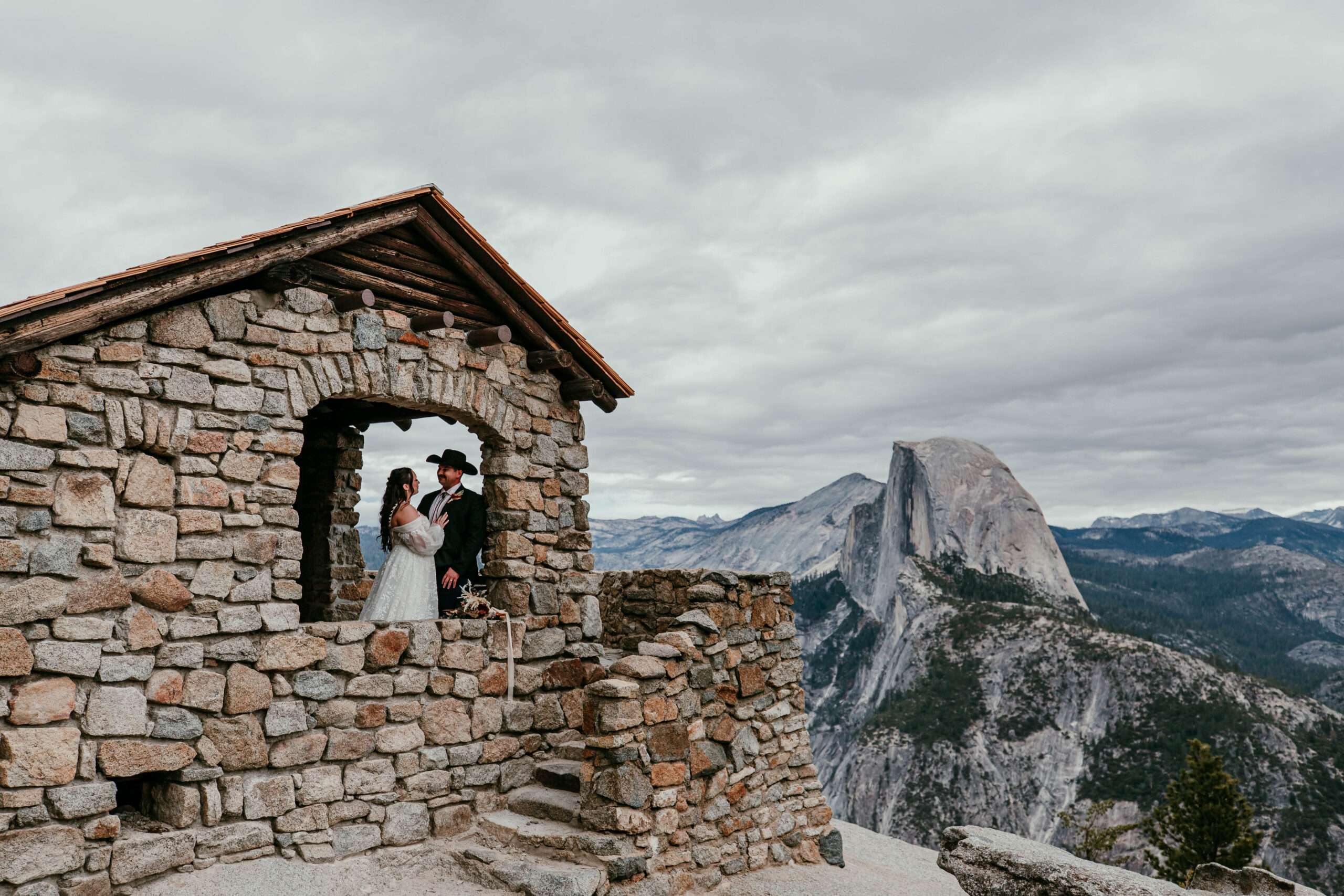 couple at Glacier Point viewpoint with Half Dome during a fall elopement in Yosemite