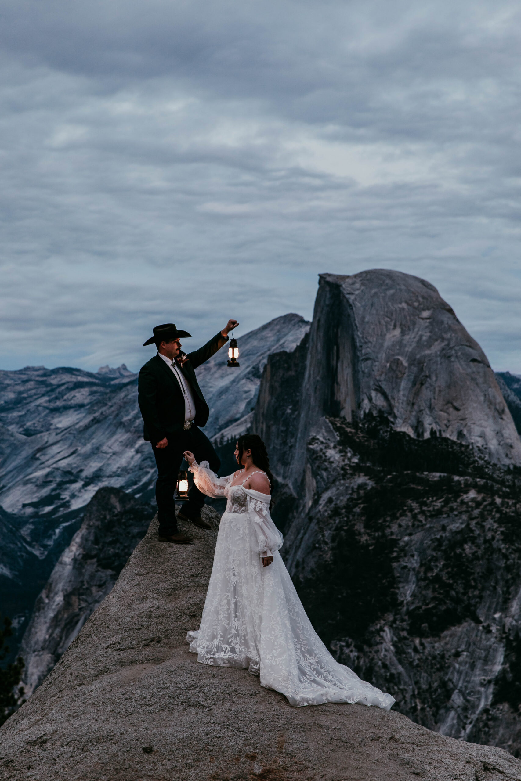 Bride and groom holding lanterns at Glacier Point Yosemite, adventurous national park wedding idea
