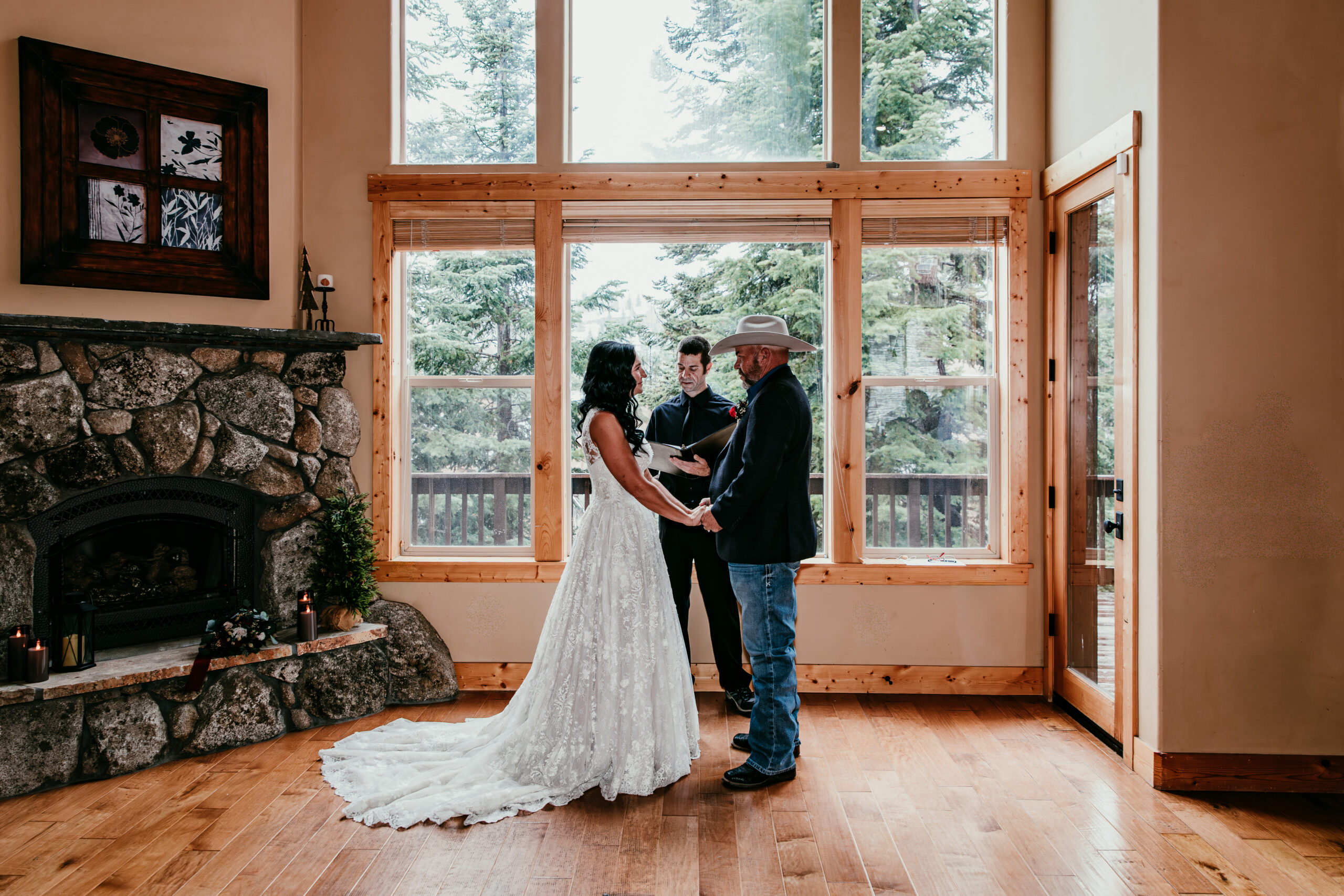 Indoor small wedding ceremony with 20 guests or less in a cozy cabin setting with large windows and natural light