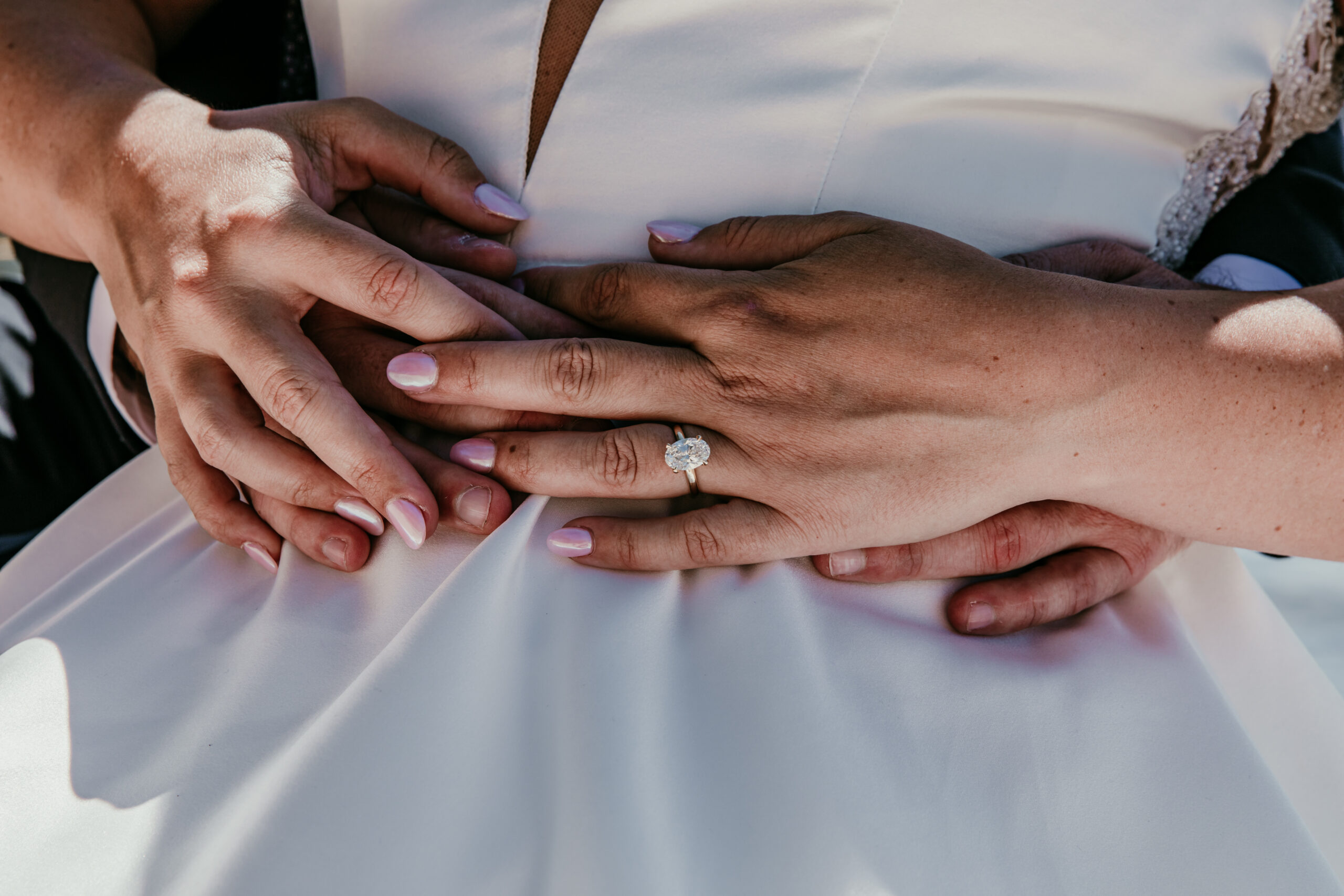 Lab-grown diamond engagement ring, oval cut solitaire on gold band, real wedding detail photo
