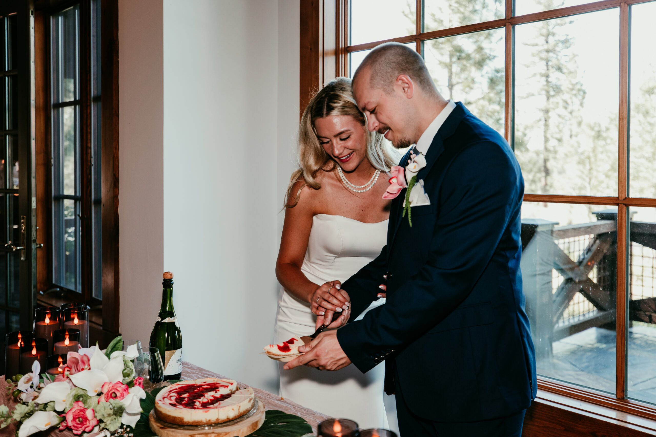 Bride and groom cutting their wedding cake inside a luxury Truckee Airbnb near Northstar and Martis Camp during their intimate Lake Tahoe wedding celebration.