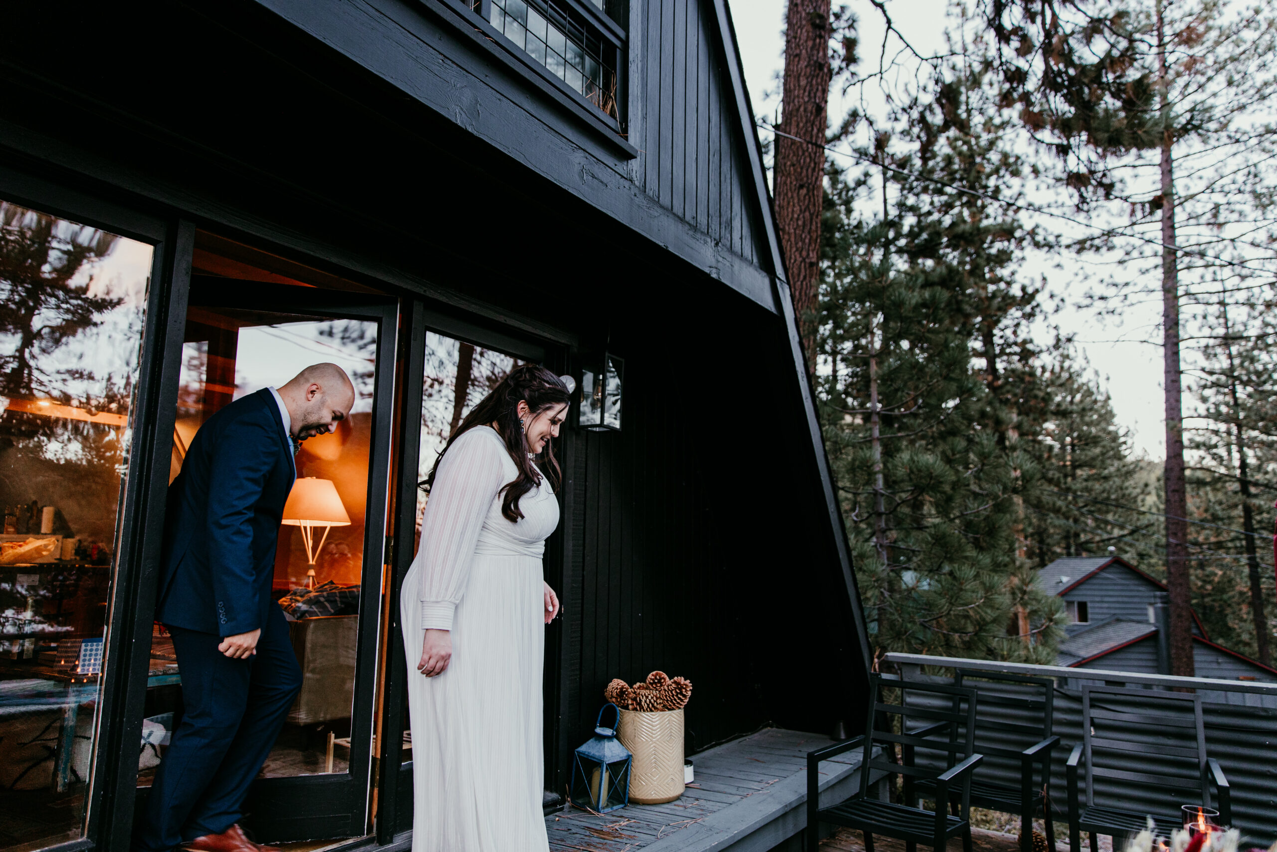Couple stepping outside a cozy A-frame Airbnb near Donner Lake in Truckee before their intimate Lake Tahoe elopement.