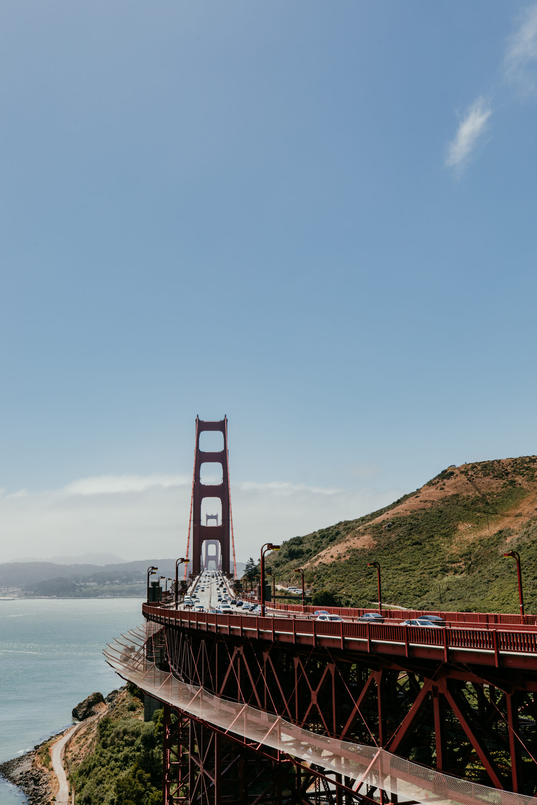 Golden Gate Bridge viewed from the Marin Headlands with the bay and hillside below.