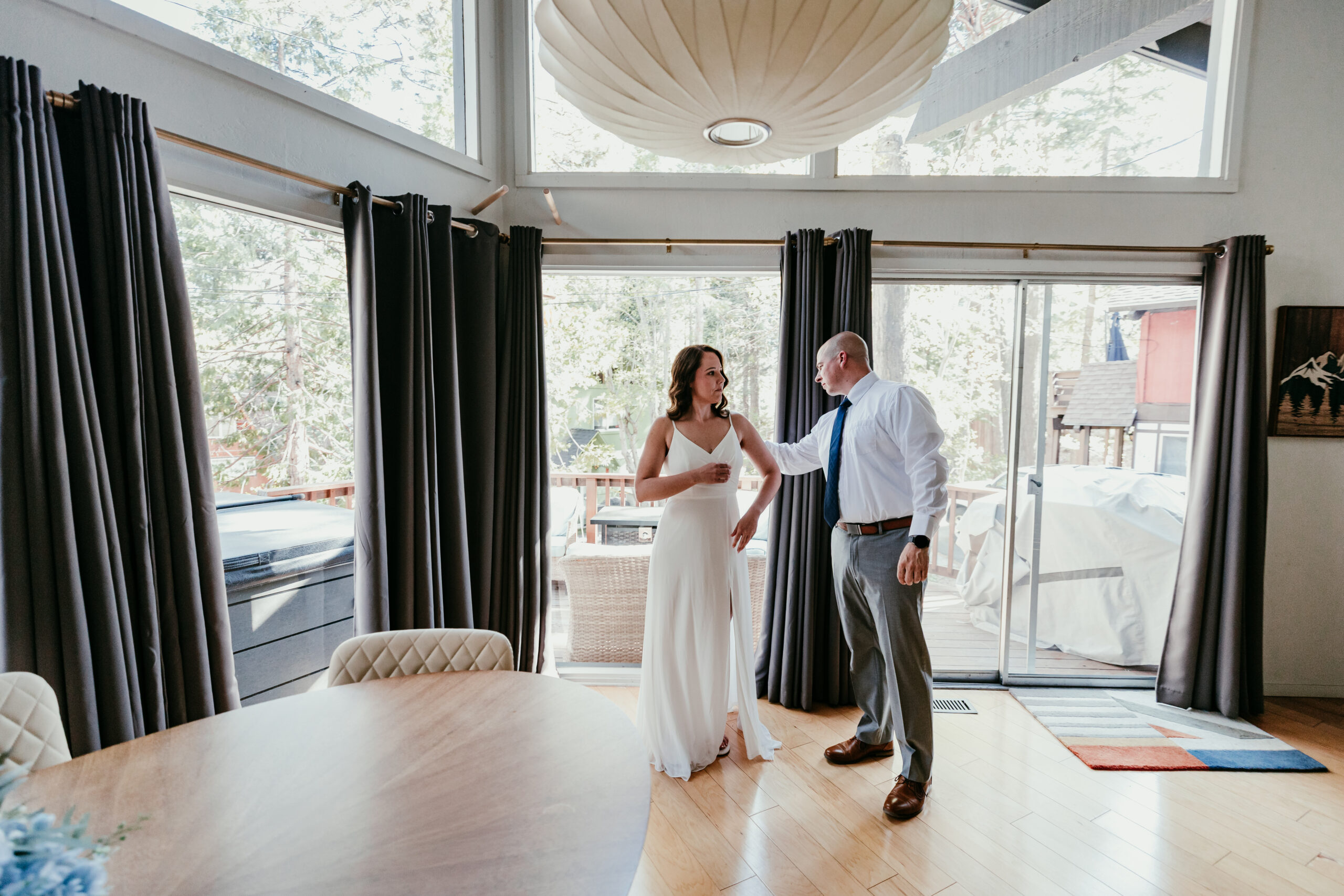 Couple getting ready together at their Lake Tahoe Airbnb before their Sand Harbor elopement.