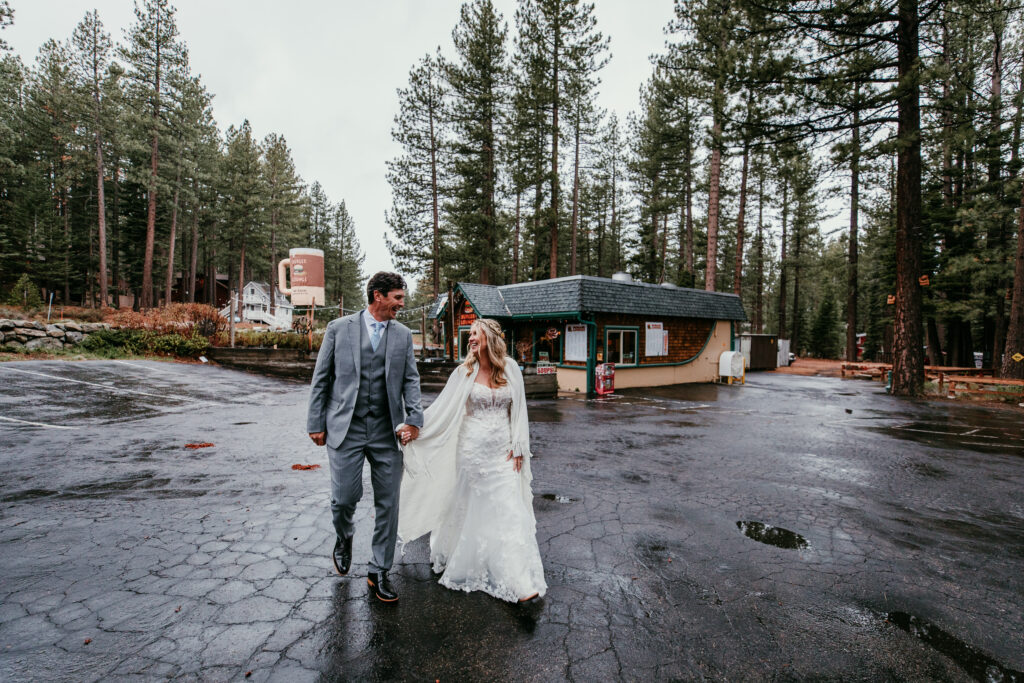 Bride and groom walking through the rain after lunch during their rainy Lake Tahoe elopement in South Lake Tahoe.