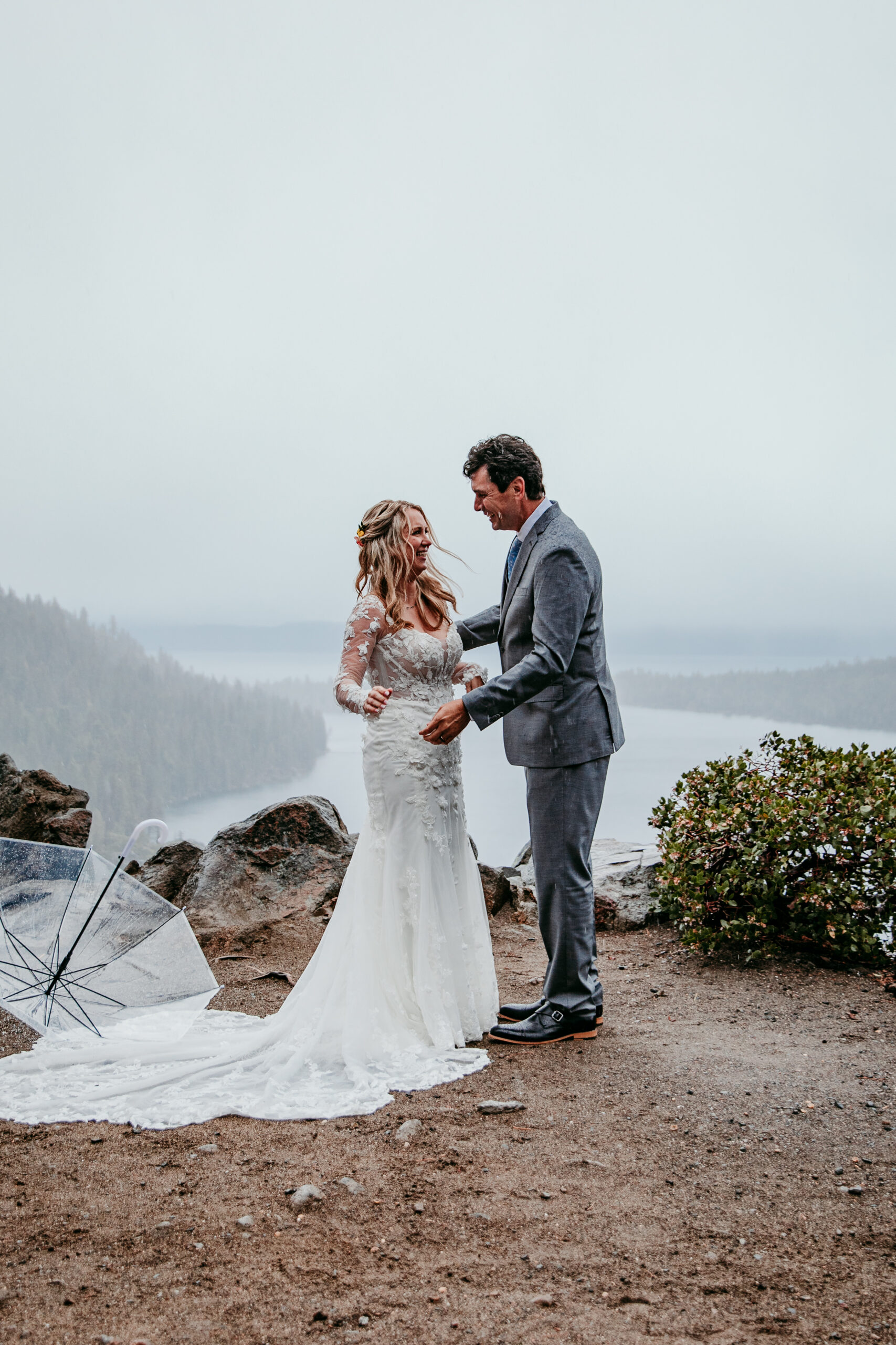 Bride and groom celebrating just after being pronounced married during their rainy Lake Tahoe elopement ceremony at Emerald Bay.