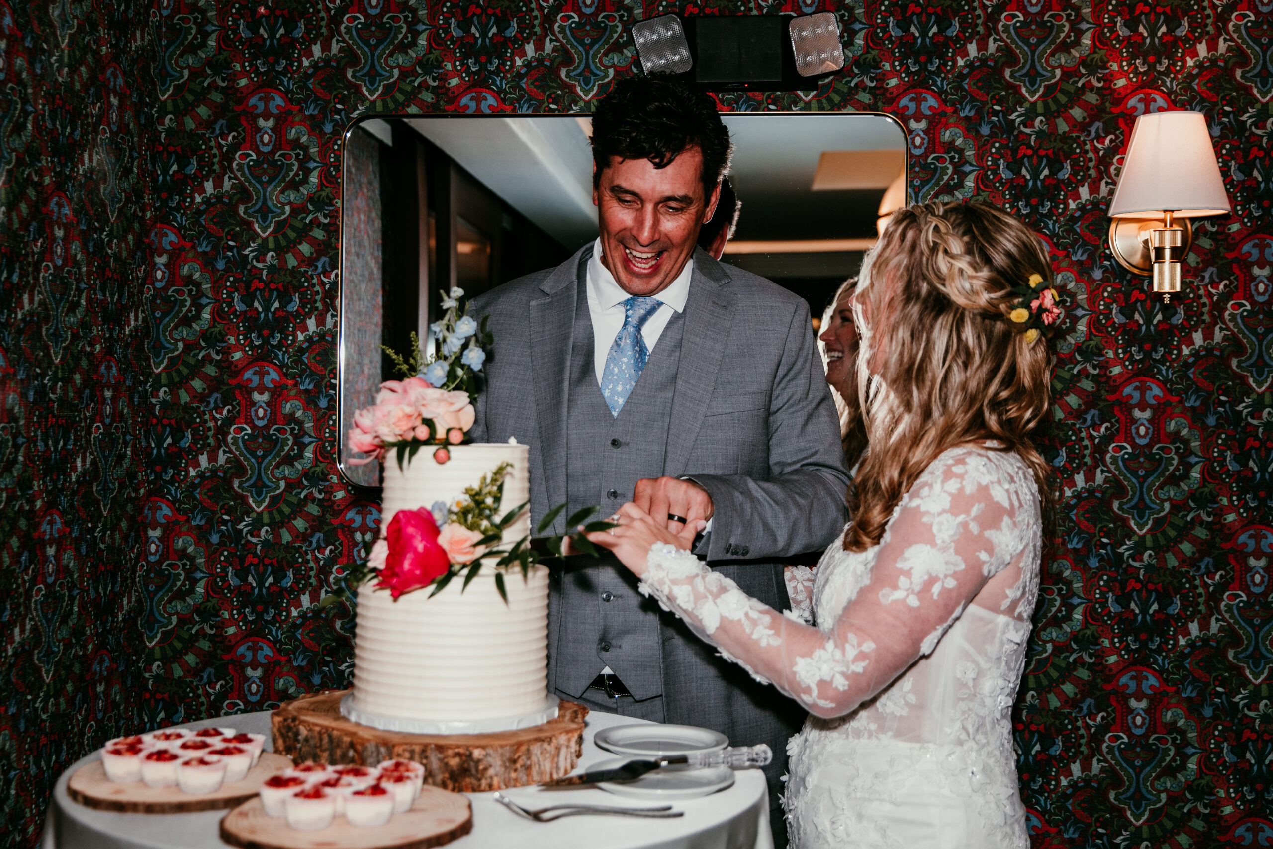 Bride and groom cutting their wedding cake at The Landing Resort after their rainy Lake Tahoe elopement reception.
