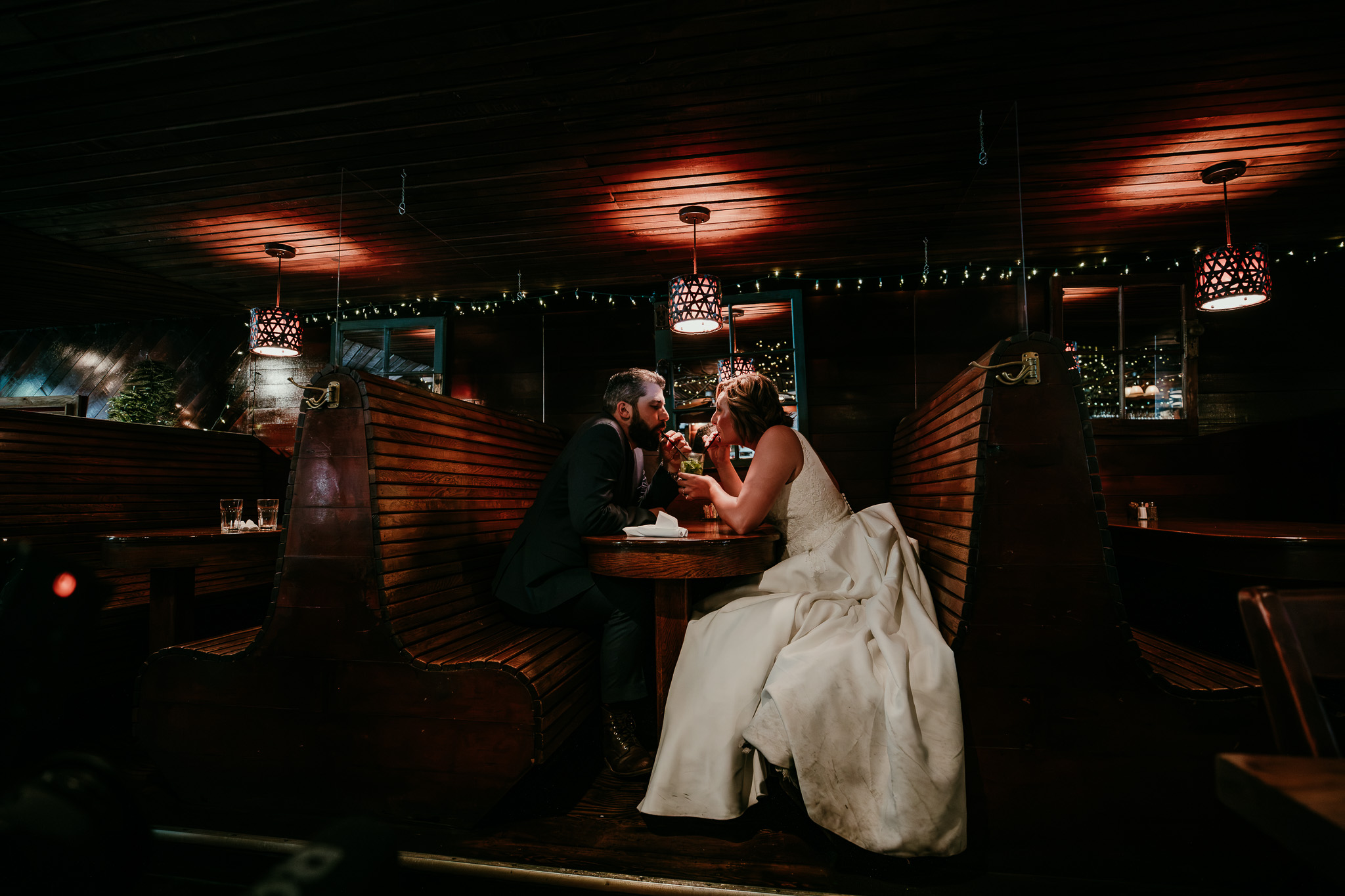 SJ and Dave sharing their first dance inside a warmly lit restaurant.