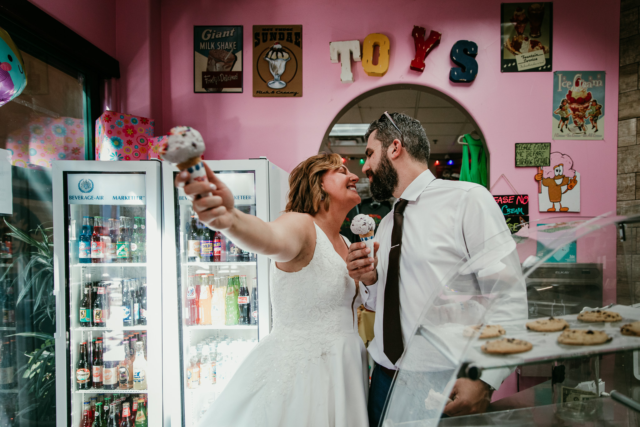 SJ and Dave kissing while holding ice cream cones during their Lake Tahoe elopement.