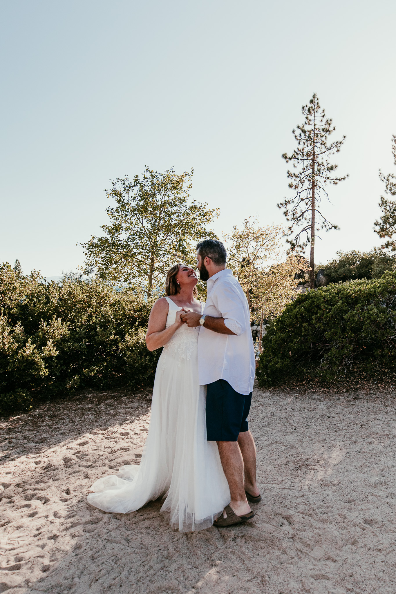 SJ and Dave sharing a kiss during their outdoor first dance at Lake Tahoe.