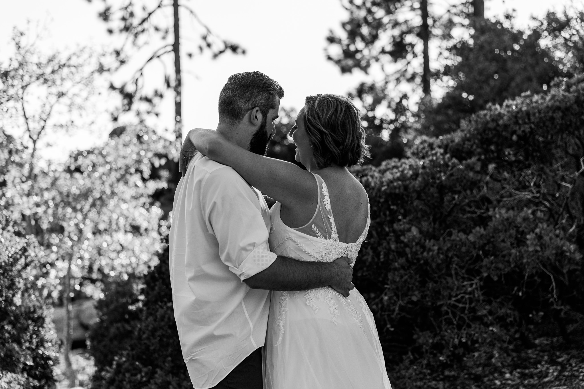Black-and-white close-up of SJ and Dave embracing during their summer Lake Tahoe elopement.